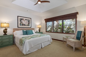 Beach house guest bedroom with a king-size bed and large windows for natural light and tropical views.