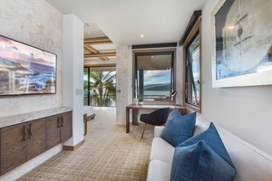 Lounge and workspace within the second primary suite, blending comfort with function.