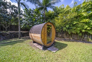Side view of private barrel sauna—your tropical escape for wellness and serenity.