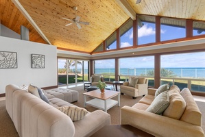 Sunlit living room with vaulted wood ceilings and sweeping Pacific vistas.