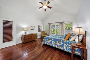 Another angle of the bedroom showing warm wood floors and plenty of space to unwind after a day of exploring.