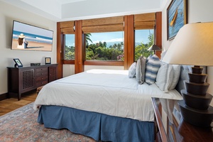Wake up to tropical paradise views through your bedroom's expansive windows, where lush palms frame the perfect morning escape.