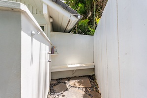 Step into your private outdoor shower sanctuary, where natural stone floors and tropical greenery create a spa-like escape.