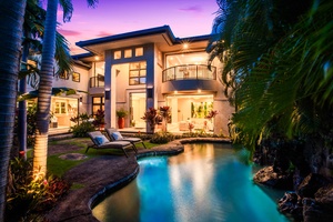 Elegant evening lighting reflects over the private pool in your island escape.