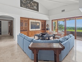 Unwind in your elegant living room with plush seating and stunning views through floor-to-ceiling windows.