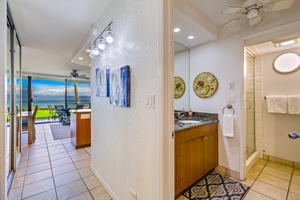 Conveniently located near the living space, Papakea L-106’s hallway bathroom features a contemporary vanity and stylish decor