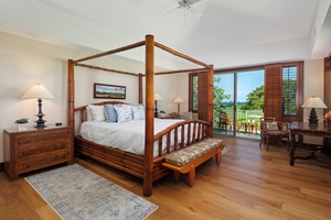 Unwind in your tropical sanctuary with elegant four-poster bed, rich wood details, and private balcony overlooking lush gardens.