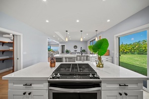 Gourmet kitchen with a central island, gas stovetop, and sleek stainless-steel finishes.