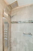 Indulge in spa-like luxury with a multi-function shower system—perfect for unwinding after beach or golf adventures.