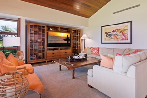 Unwind in your spacious living area with plush seating, entertainment center, and warm tropical touches throughout.