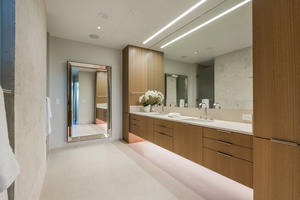 Indulge in your luxurious ensuite with elegant double vanities, warm wood cabinetry, and premium fixtures for your daily rituals.