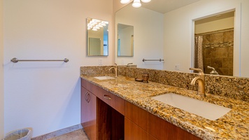 The warm wood tones and double vanity in this high end guest bathoom.