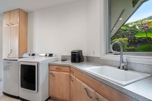 Over sized laundry room with washer, dryer and large sink