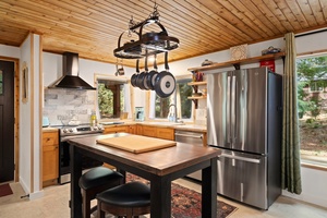 Charming copper pots and curated accents bring warmth and personality to your cooking space.