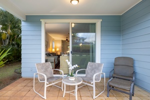 Relax on your private lanai with comfortable seating, perfect for morning coffee or evening conversations with tropical plants nearby.