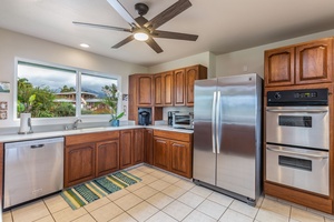 The spacious kitchen offers stainless steel appliances, generous counter space, and everything you need for island-inspired meals.