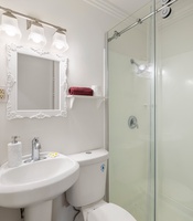 Clean and bright, this full bathroom features a walk-in shower and updated finishes—just steps from the main living and guest rooms.