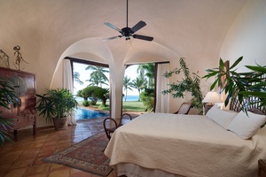 Primary bedroom featuring a private patio with oceanfront view.