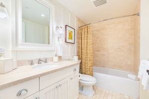 Guest bathroom Spacious bathroom with a vanity, large mirror, and clean white finishes.