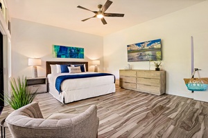 With modern furnishings and natural light, the spacious primary bedroom at Kapalua Ridge 1421 opens to a private lanai.