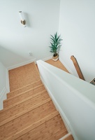 Ascend the beautifully crafted wooden staircase to your private upper level, where natural light and thoughtful design details create a welcoming atmosphere.