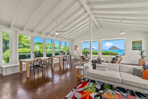 Relax in this bright, open living space with sweeping ocean views and island peaks framing your stay. High vaulted ceilings and natural light create a warm, inviting retreat.