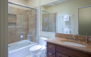 Guest ensuite with a tub/shower combo and ample counter space for comfort and convenience.