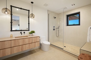 Private spa-like bathroom with sleek glass shower and modern vanity—designed for comfort and ease during your stay.