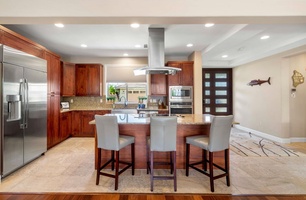 The fully-stocked kitchen has breakfast bar for three.