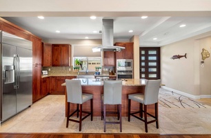 The fully-stocked kitchen has breakfast bar for three.