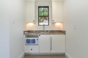 Charming kitchenette in the carriage house with microwave and sink.