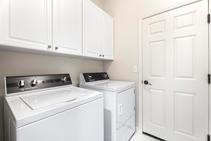 Laundry room with washer and dryer for easy vacation living.