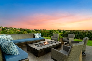 Gather around the rooftop fire pit as twilight paints the sky in stunning pastels above rolling green landscapes.