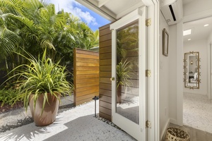 Primary ensuite bathroom open to private outdoor shower area