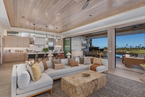 This spacious living area blends modern elegance with rustic charm, highlighted by a striking wooden coffee table at its center.