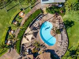 Napili Shores F-252 guests enjoy a stunning resort pool surrounded by lush island scenery.