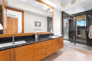 Ensuite bath with dual sinks and walk-in glass shower.