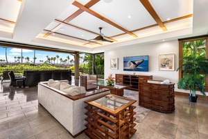 The great room opens fully to the lanai, inviting seamless indoor–outdoor living.