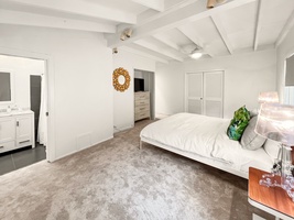 The suite has vaulted ceiling, modern touches, and a comfortable bed.