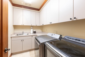Fully equipped laundry room with sink and folding counter—great for long stays and families.