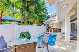 Private courtyard pool surrounded by lush foliage, perfect for lounging and soaking up the sun.