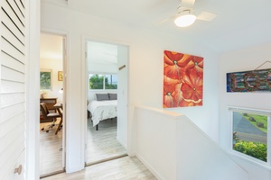 Top-of-stairs landing connects all three bedrooms with garden views at every turn.