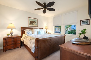 Cozy guest bedroom two offers a king bed and natural lighting.