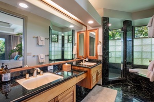 Dual vanity bathroom with rich wood finishes and natural light — perfect for couples or shared stays.
