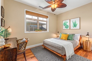 Upstairs third bedroom with double bed, desk, and adjacent full bath.