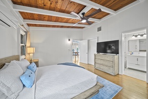 Spacious primary suite angle highlighting ample storage, calming décor, and room to unwind after a day in the sun.