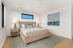 Your peaceful bedroom features a plush bed and calming ocean artwork, creating your perfect coastal retreat.