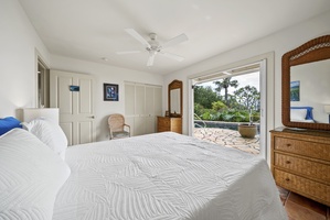 Wake up to tropical garden views from your serene bedroom with a queen bed. Rattan furniture and ceiling fan create island vibes.