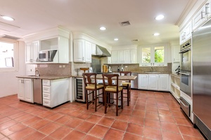 Fully-equipped kitchen, with classic white cabinetry and a large central island for casual dining and meal preparation.Fully-equipped kitchen, with cla