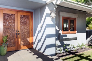 Beautifully hand carved door welcomes you inside this home